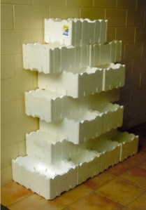 Interlocking boxes against a wall. Sould suit herbs and smaller, trailing vegetables.