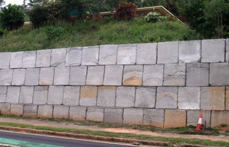 Retaining wall built with solid concrete blocks.