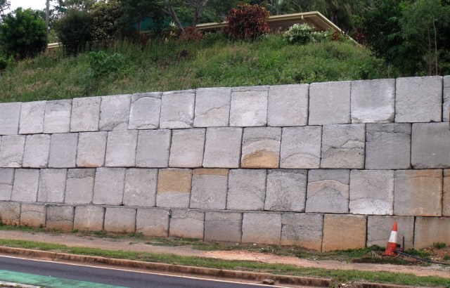 Retaining wall built with solid concrete blocks.