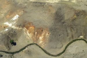 Erosion gullies forming on steep slopes due to set stocking and overgrazing near Melbourne Australia. The tre